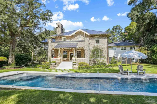 a view of a backyard with a patio and fire pit
