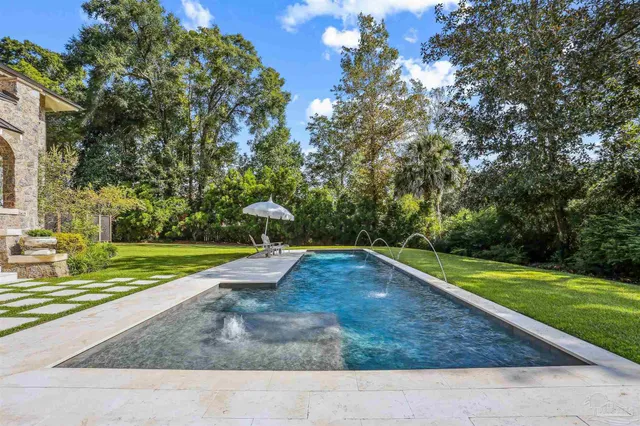 a living room with furniture and a book shelf
