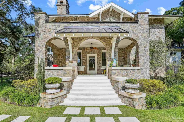 a bathroom with a toilet sink vanity tub and mirror
