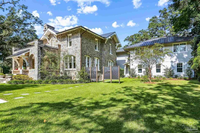 a room with granite countertop lots of wooden furniture and shoes