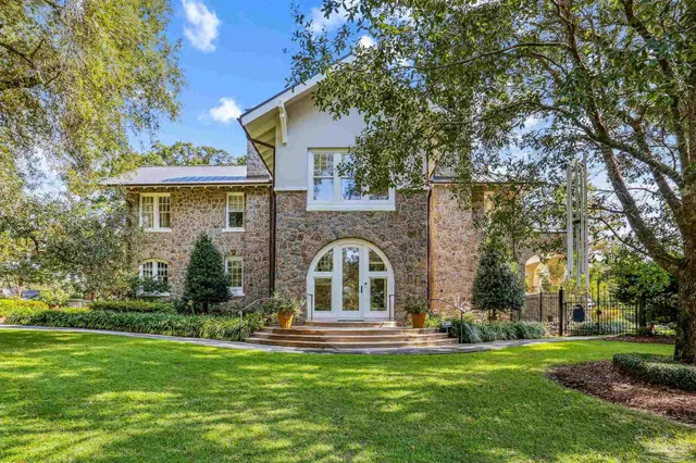 a view of a brick house with large windows