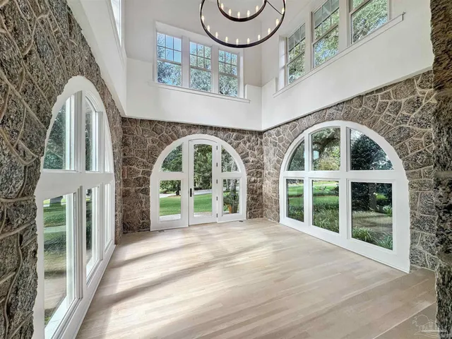 a large white kitchen with kitchen island a sink a stove and a refrigerator
