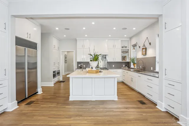 a living room with furniture and kitchen view