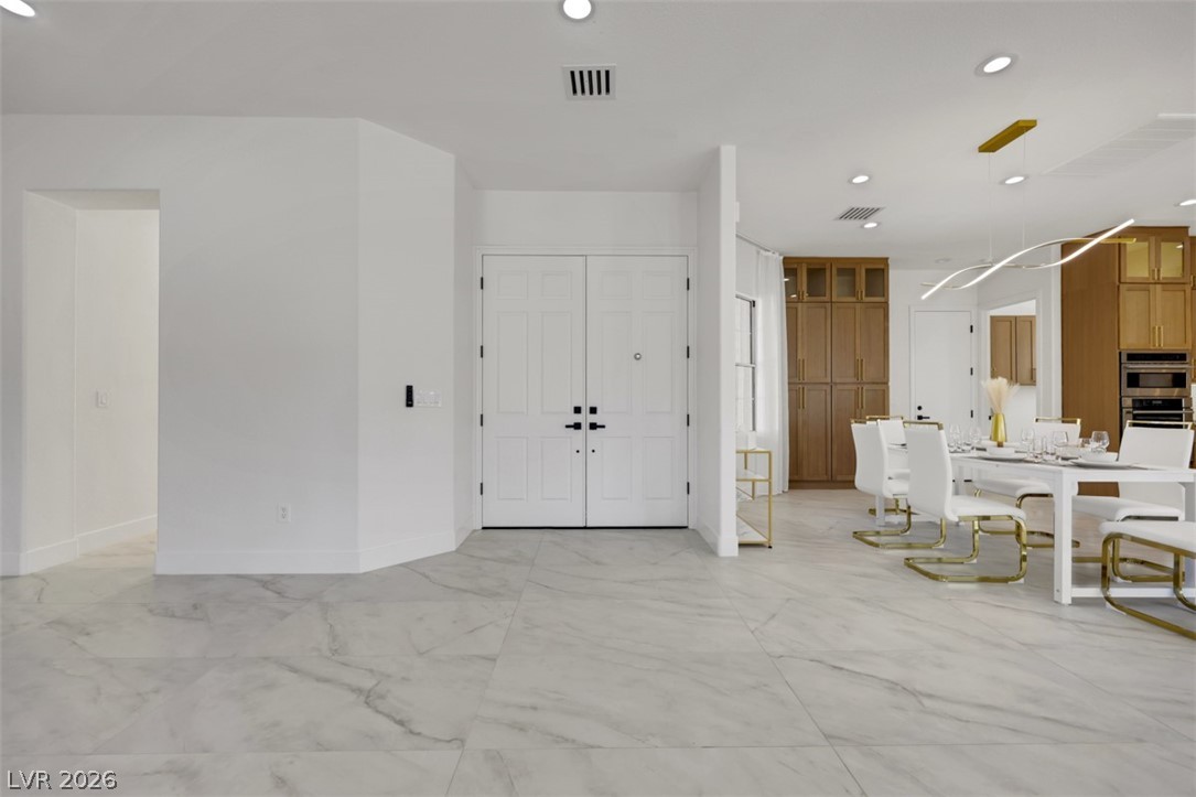 5015 Rivedro Street Las Vegas, NV 89135 - Photo 51 of 91 A grand entrance welcomes guests, flowing seamlessly into the dining area.