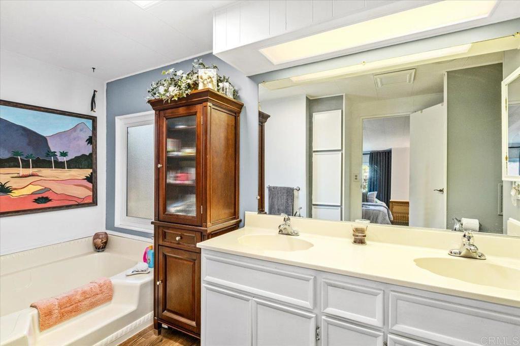 18218 Paradise Mountain Road, Unit 116 Valley Center, CA 92082 - Photo 7 of 35 a bathroom with a sink double vanity and a bathtub