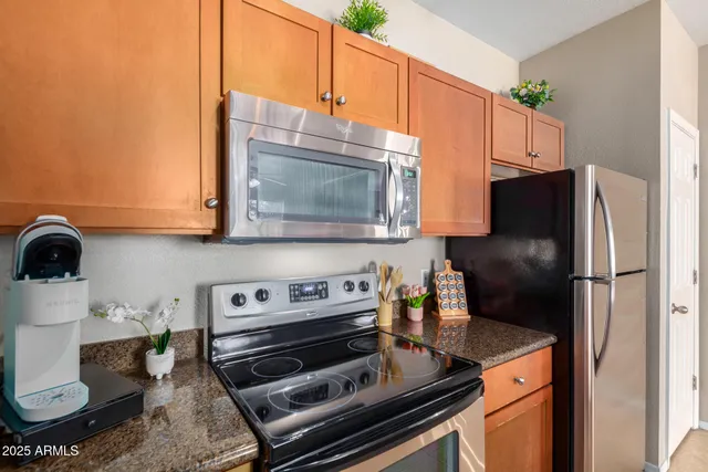 a kitchen with a stove and a refrigerator