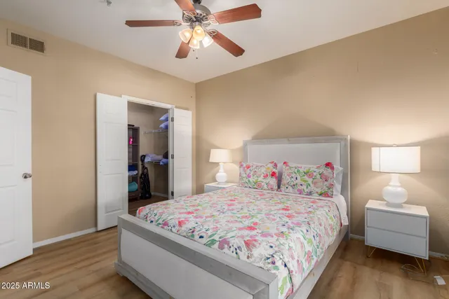 a bedroom with bed and a chandelier