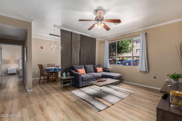 a living room with furniture and wooden floor