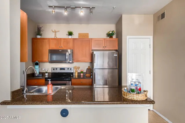 a kitchen with counter top space and stainless steel appliances