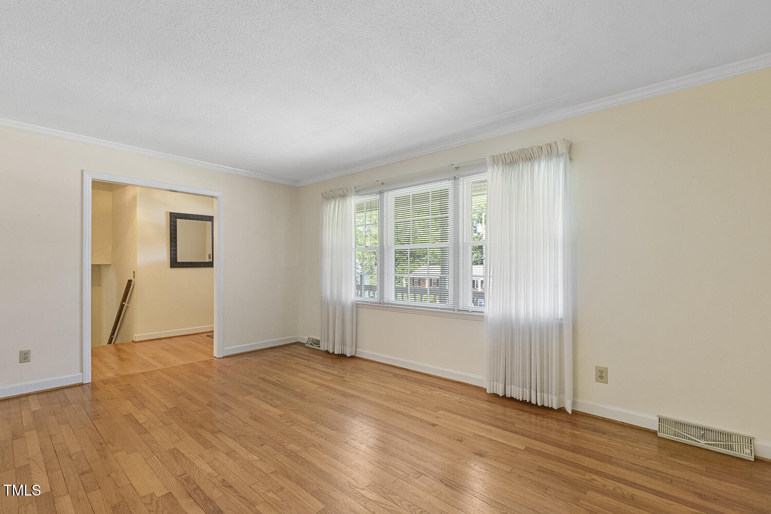 1000 Winona Road Raleigh, NC 27609 - Photo 9 of 36 an empty room with wooden floor and windows