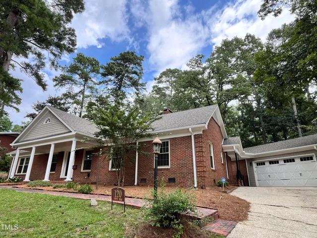 a bathroom with a granite countertop sink a mirror a shower and vanity