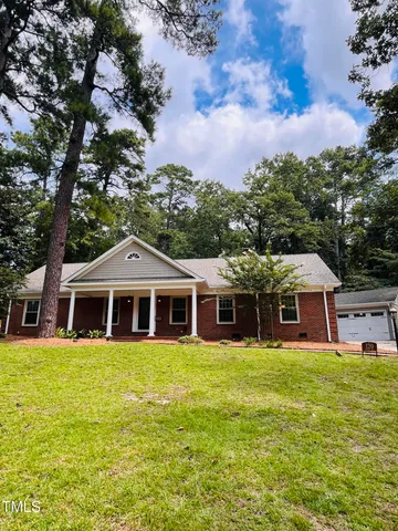 a view of a house with a large tree
