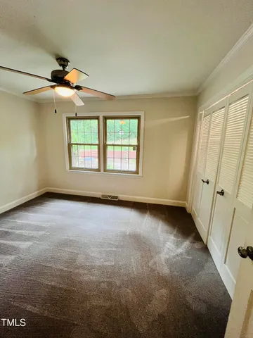 a room with a bed and a television