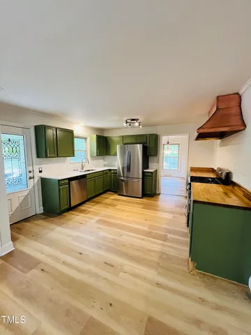 a view of an ocean with a house in the background