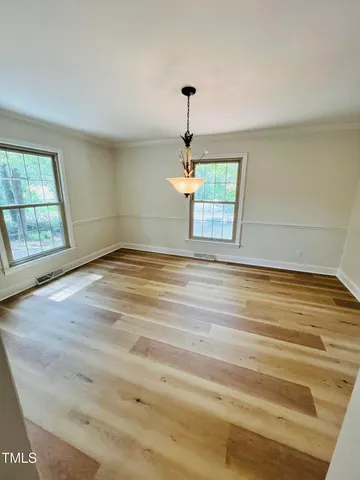 a view of a living room with furniture and a flat screen tv
