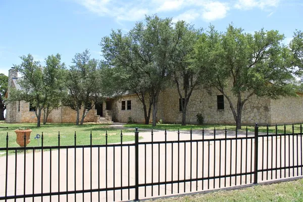 a front view of a house having trees
