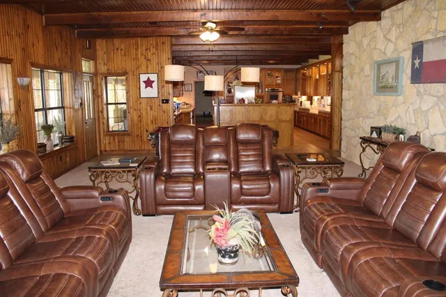 a living room with furniture fireplace and a large window