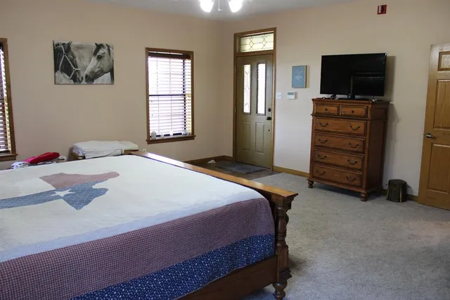 a bedroom with a bed and a flat screen tv