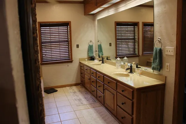 a bathroom with a double vanity sink and a mirror