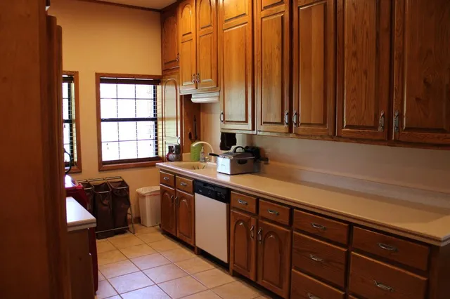 a kitchen with stainless steel appliances a sink and cabinets