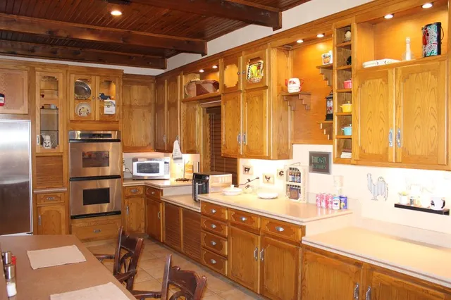 a kitchen with a sink appliances and cabinets