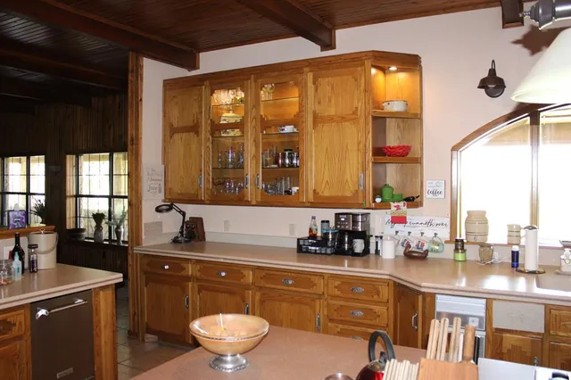 a kitchen with a sink stove and cabinets