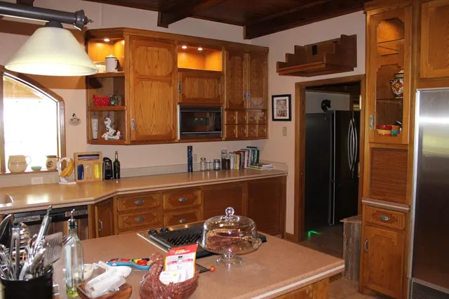 a kitchen with stainless steel appliances a sink stove and refrigerator
