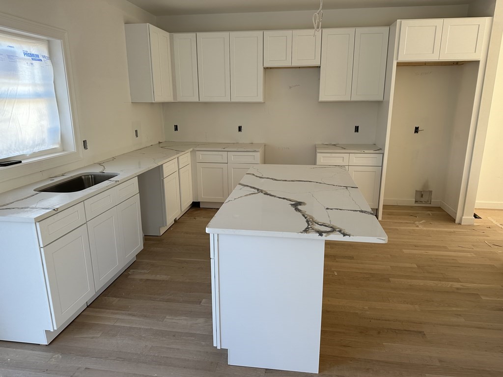 249 Groton Road, Unit 2 Chelmsford, MA 01863 - Photo 13 of 23 a kitchen with a sink stove and cabinets