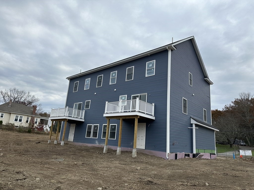 249 Groton Road, Unit 2 Chelmsford, MA 01863 - Photo 15 of 23 a front view of a house with a yard