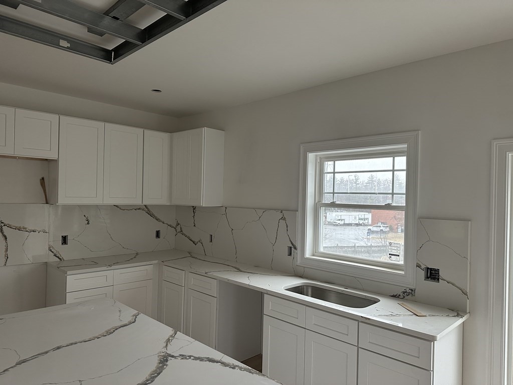 249 Groton Road, Unit 2 Chelmsford, MA 01863 - Photo 17 of 23 a kitchen that has a sink and a stove