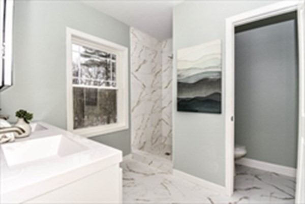 249 Groton Road, Unit 2 Chelmsford, MA 01863 - Photo 2 of 23 a bathroom with a sink and a shower