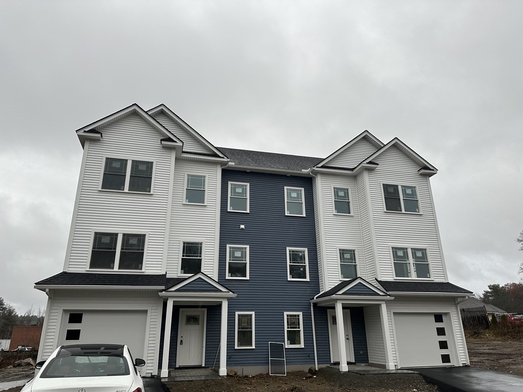249 Groton Road, Unit 2 Chelmsford, MA 01863 - Photo 21 of 23 a front view of a house with yard