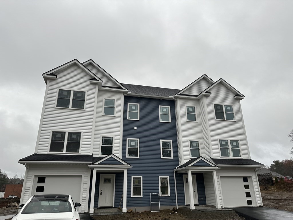 249 Groton Road, Unit 2 Chelmsford, MA 01863 - Photo 22 of 23 a front view of a house with a yard