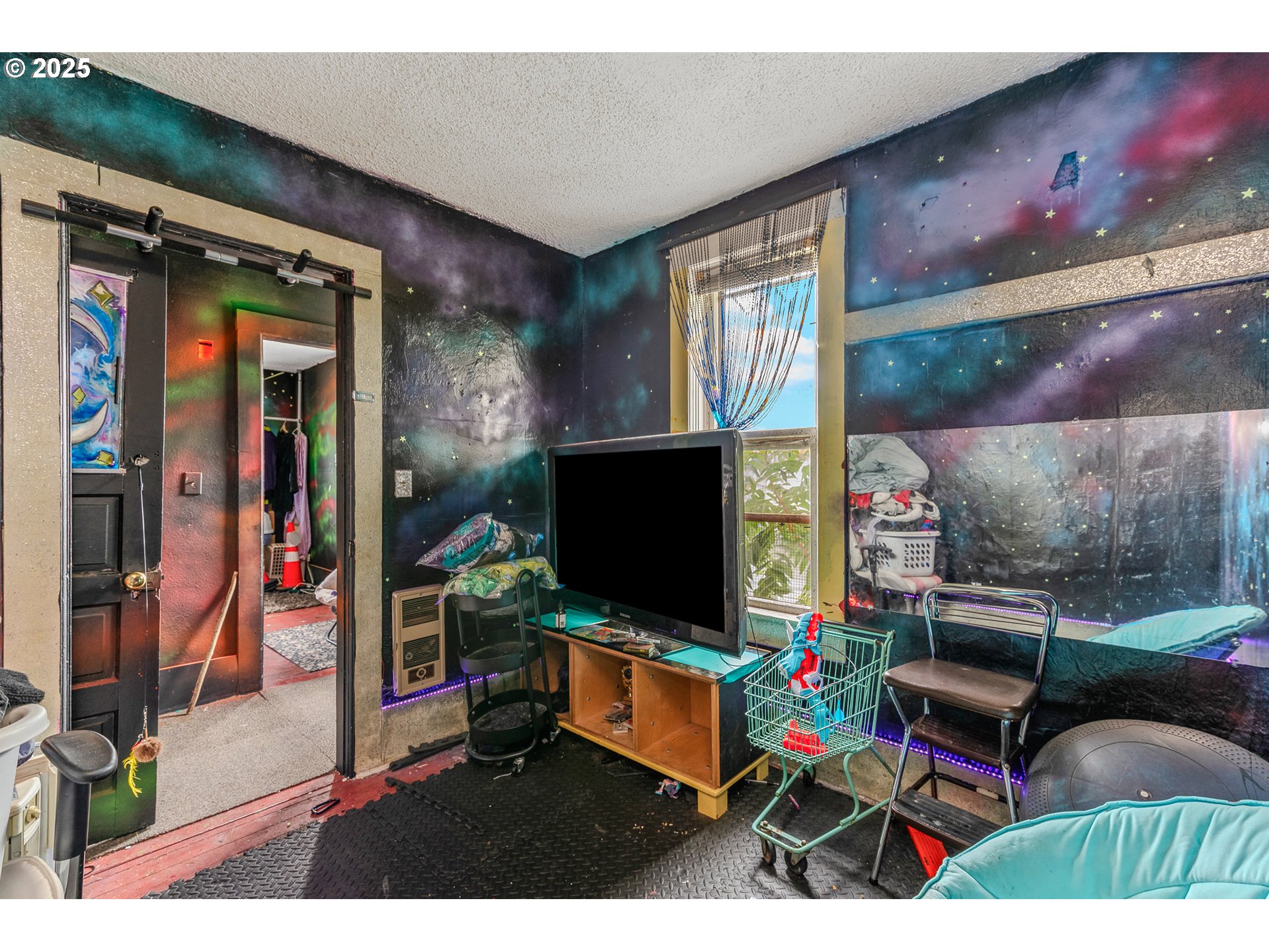 2026 C Street Washougal, WA 98671 - Photo 28 of 36 a living room with furniture and a flat screen tv