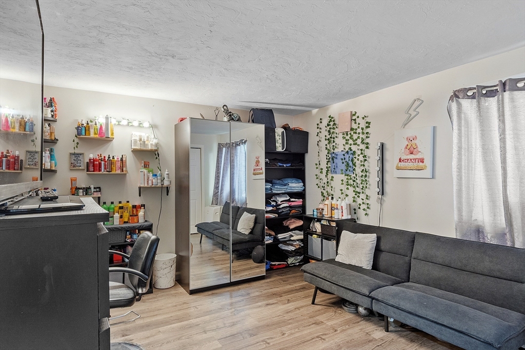 10 Dryden Street, Unit 7 Worcester, MA 01605 - Photo 12 of 24 a living room with furniture and a large window