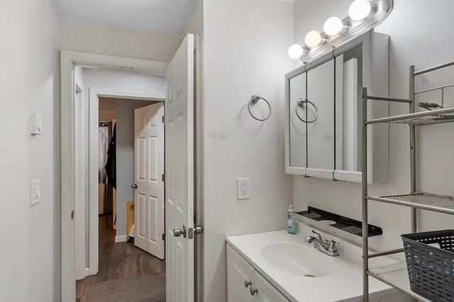 a bathroom with a sink a mirror and a shower