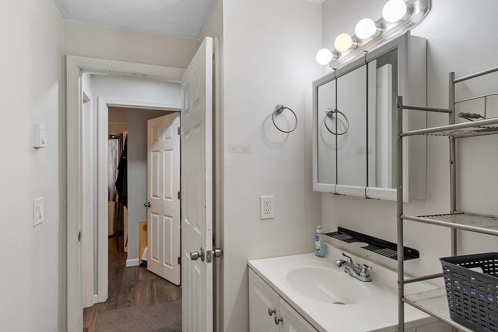 10 Dryden Street, Unit 7 Worcester, MA 01605 - Photo 18 of 24 a bathroom with a sink a mirror and a shower