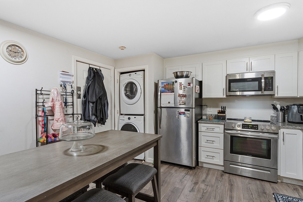 10 Dryden Street, Unit 7 Worcester, MA 01605 - Photo 5 of 24 a kitchen with stainless steel appliances a stove a sink and a refrigerator