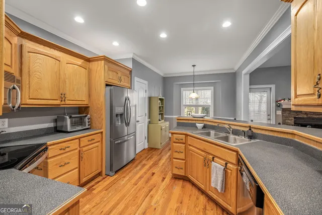 a kitchen with stainless steel appliances granite countertop a sink stove and refrigerator