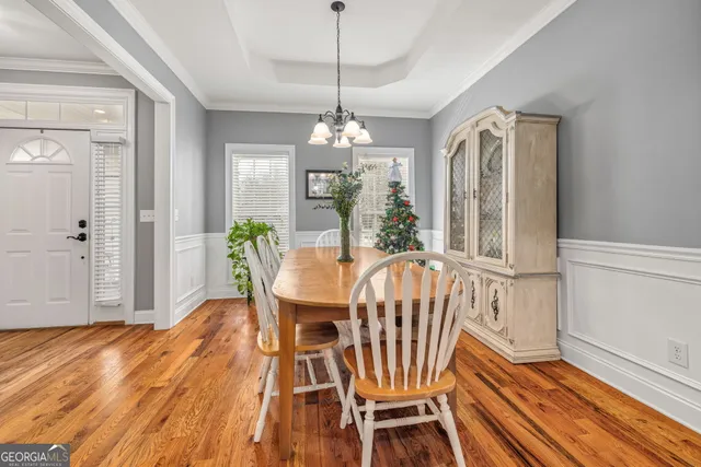 a view of a dining room with furniture window and wooden floor