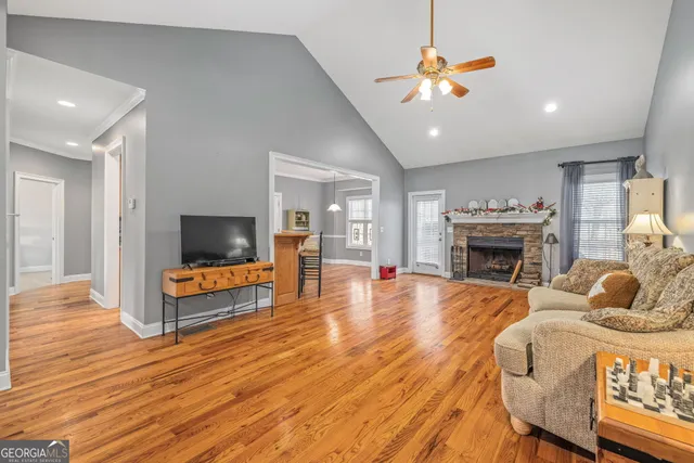 a living room with furniture a fireplace and a flat screen tv