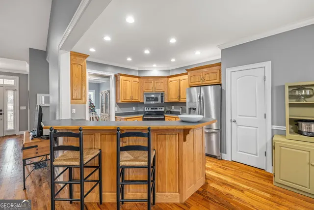 a kitchen with stainless steel appliances granite countertop a stove a sink dishwasher and a refrigerator