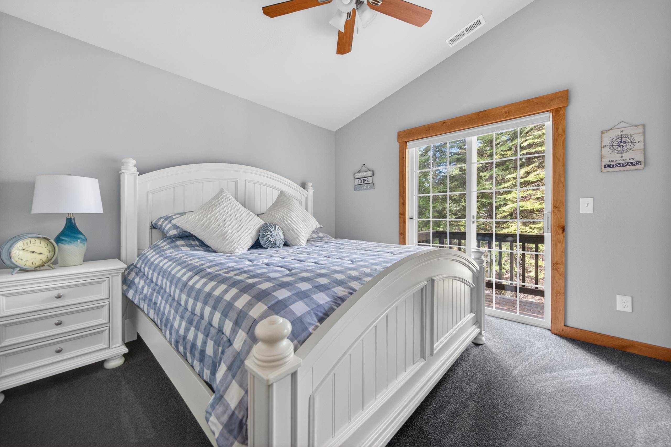 1220 Lynx Road Lake Almanor, CA 96137 - Photo 22 of 45 a bedroom with a large bed and a chandelier fan