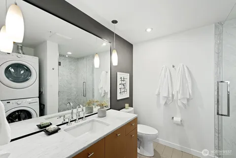 a bathroom with a sink a toilet and a mirror