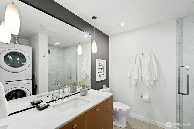 a bathroom with a sink a toilet and a mirror