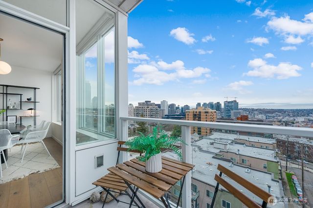 a view of a balcony with two chairs and a table