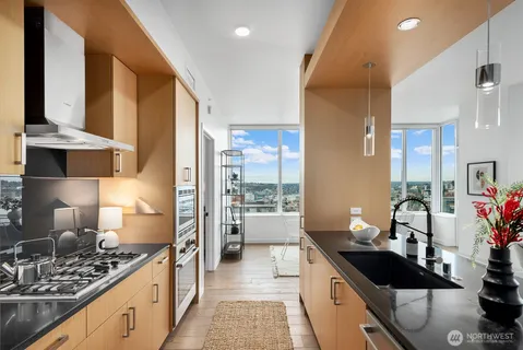 a kitchen with stainless steel appliances a sink stove and refrigerator