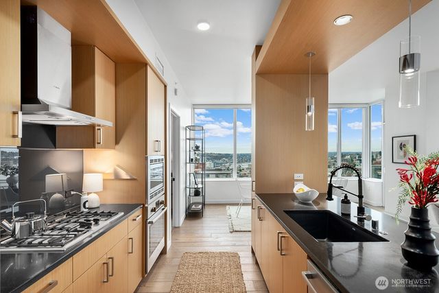a kitchen with stainless steel appliances a sink stove and refrigerator