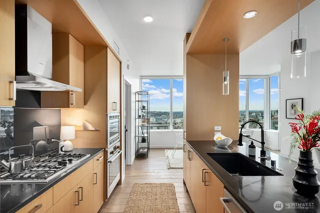 a kitchen with stainless steel appliances a sink stove and refrigerator