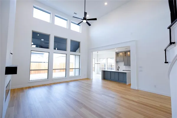 a kitchen with stainless steel appliances granite countertop a sink cabinets and wooden floor